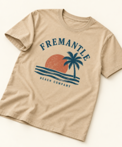 Sand Retro Sunset Tee angled flat lay with navy palm, waves and rust-orange sunset artwork